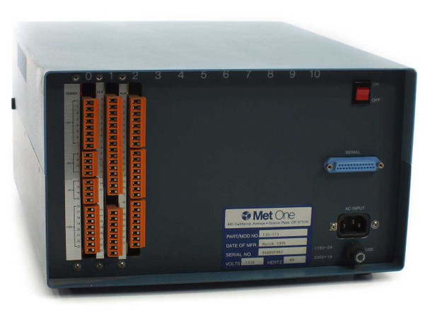 Met One 130-115 Data Multiplexer – rear panel showing 10-slot card cage with 3 installed orange-tabbed expansion cards, D-sub serial port, IEC AC power inlet, and ON/OFF switch
