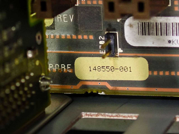 Close-up of motherboard part number label: 148550-001, with REV and PARE markings visible on PCB