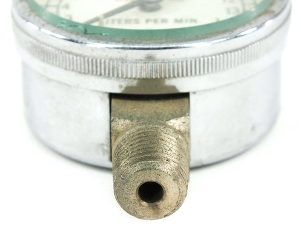 Close-up of 1/2" NPT brass bottom fitting on Marsh Instrument flow gauge showing threads and port opening