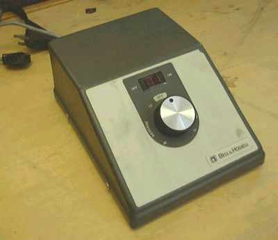Bell & Howell 1393E Microfilm Reader Motor Controller – front three-quarter view showing rotary knob, LED digital display, and Bell & Howell logo