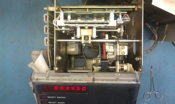 Simplex 1302 time clock – internal view with front panel open showing card-punch mechanism, motor, LED display active (00:39:50), and SELECT SWITCH / SELECT AGAIN indicators