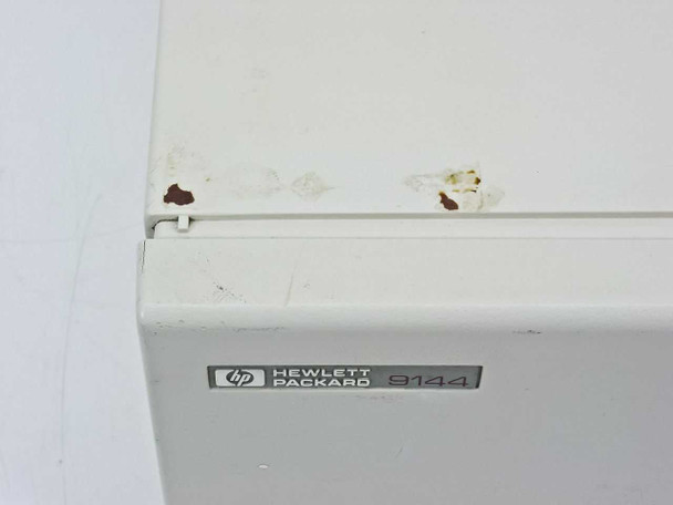 HP 9144A tape drive – top left corner showing surface rust spots and paint chipping at the case seam near the HP Packard 9144 badge
