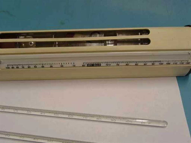Close-up of psychrometer scale and thermometer slots showing internal rust damage from battery acid corrosion