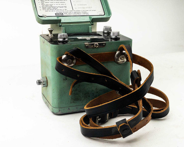 MSA Model 20 Combustible Gas Indicator — close-up three-quarter view with lid open, front panel controls and leather carry strap detail