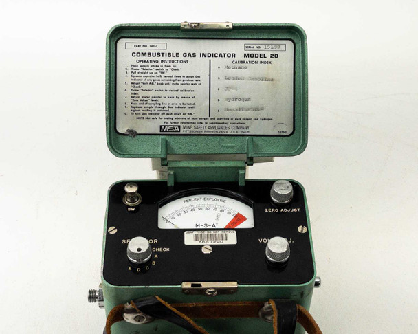 MSA Model 20 Combustible Gas Indicator — front panel close-up showing M-S-A branded analog percent explosive meter, Sensitizer, Battery Check, Zero Adjust, and Voltmeter controls; instruction/calibration card visible inside lid