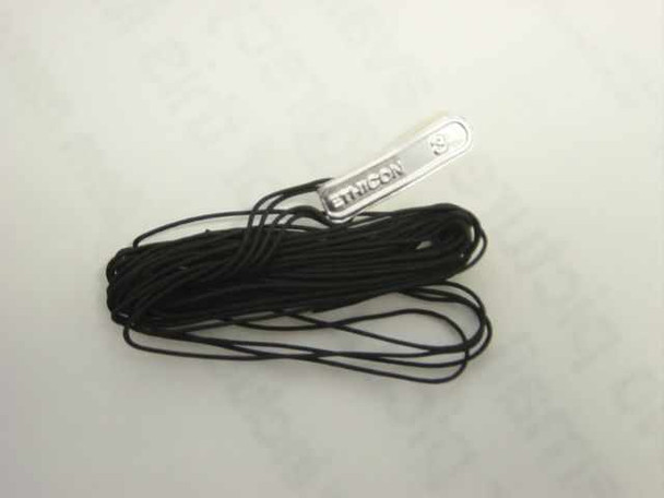 Ethicon SA-9 Silk Black Braided Suture — two strands of black braided silk suture uncoiled, with Ethicon foil packet label visible