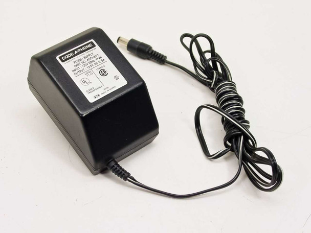 Code-A-Phone ACC-541 power supply — front-left three-quarter view showing black housing, barrel output connector, and coiled cord
