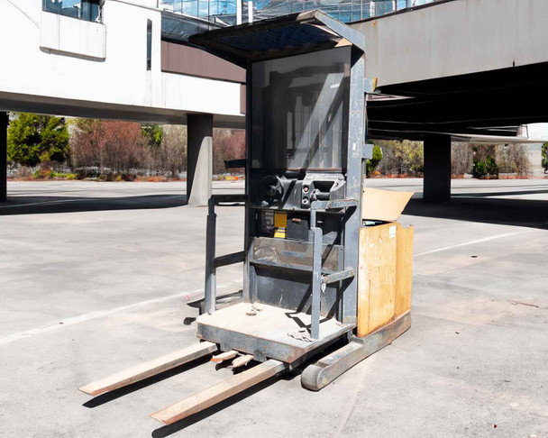 Clark OP15 counterbalanced electric order picker forklift – left side view outdoors showing mast, overhead guard, and forks