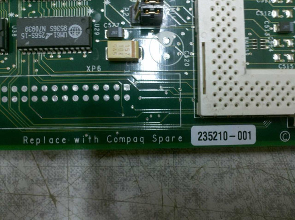 Compaq 235210-001 board edge close-up showing 'Replace with Compaq Spare' silkscreen and part number label