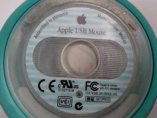 Apple M4848 bottom label close-up showing model number M4848, Apple USB Mouse, Assembled in Malaysia, CE UL FCC markings