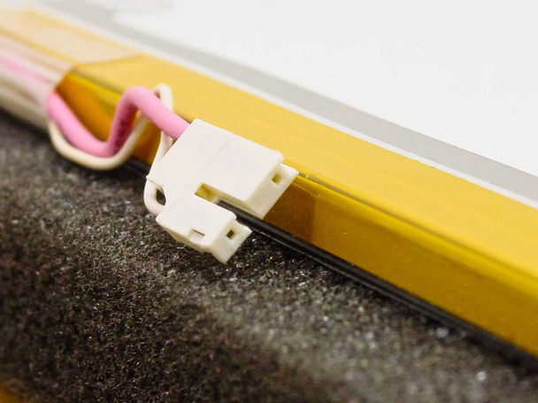 Close-up of Toshiba LTM13C417L LCD panel corner showing white 28-pin connector and pink backlight cable