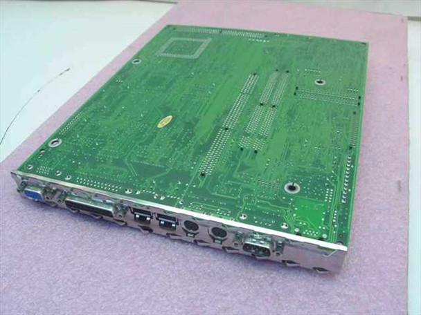 IBM PC 300GL 61H0382 motherboard bottom view showing PCB traces and solder side, with I/O port bracket visible along the edge including VGA, parallel, PS/2, and serial connectors