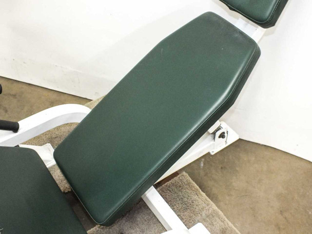 Hoist F-355 leg press main seat pad close-up – dark green vinyl showing relatively intact upper surface with minor wear