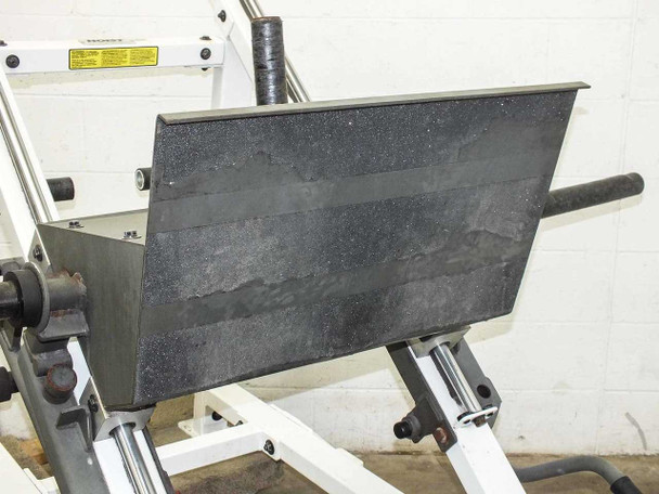 Hoist F-355 leg press footplate close-up – large rubberized black textured surface with horizontal wear striations and horizontal loading bar
