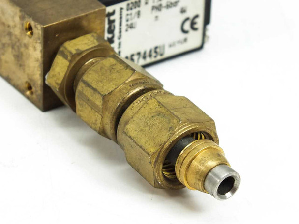 Burkert 0200 A miniature solenoid valve 057445U — close-up of brass compression fitting outlet showing ferrule, compression nut, and stainless orifice tip