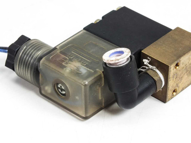 Burkert 0200 A miniature solenoid valve 057445U — rear/coil-end view showing transparent DIN connector body, push-in fitting elbow, and brass valve body ports