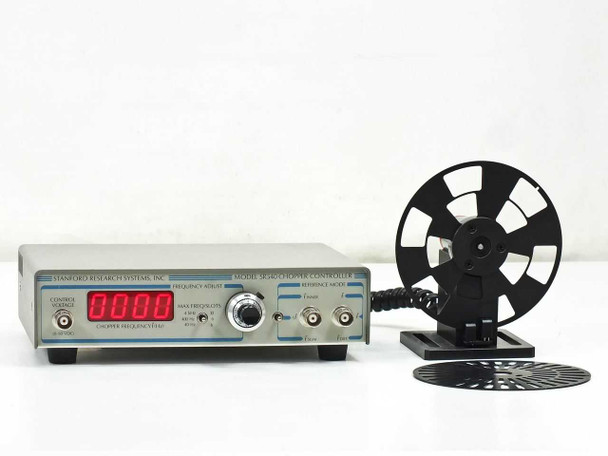 Stanford Research Systems SR540 Optical Chopper Controller front panel with red LED frequency display, SR541 motor head with 6-slot blade on stand, and 30-slot blade in foreground