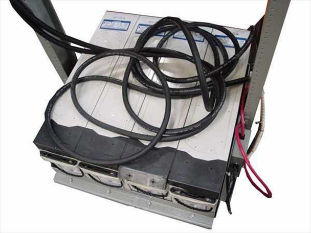 AGM battery string at base of power plant frame with interconnect cabling and red/black DC leads