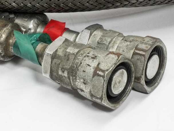 Macro view of Aeroquip 5400-S5-8 refrigerant coupling end fittings on CTI 8043074 cryopump helium compressor lines, showing red and green color-coded coupling nuts and flat-face sealing surfaces