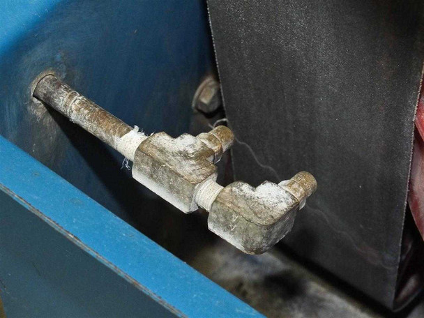 CRL 2200RP water plumbing fittings inside sump basin showing mineral scale and deposit buildup on pipe joints
