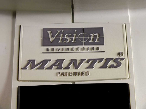 Close-up of Vision Engineering MANTIS PATENTED embossed nameplate badge on microscope housing