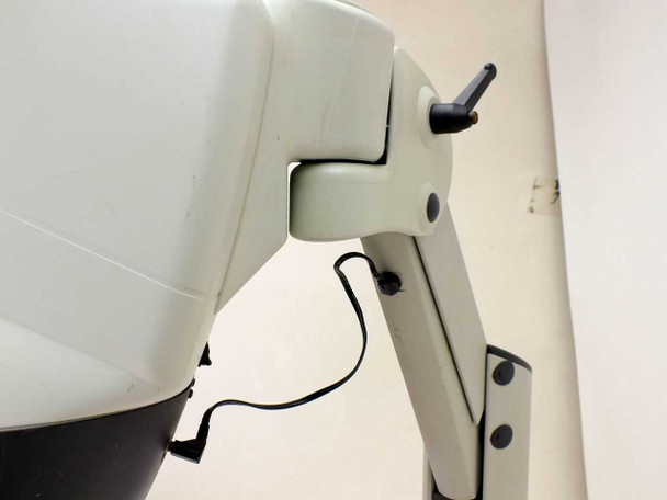Close-up of Mantis articulating arm hinge joint showing tension adjustment, pivot mechanism, and power cable routing; scuffing visible on arm surfaces