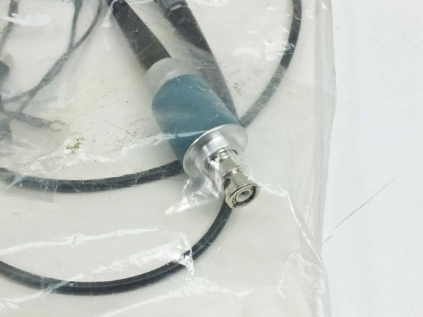 Close-up of Tektronix P6008 probe body showing teal/blue attenuation collar and BNC connector end