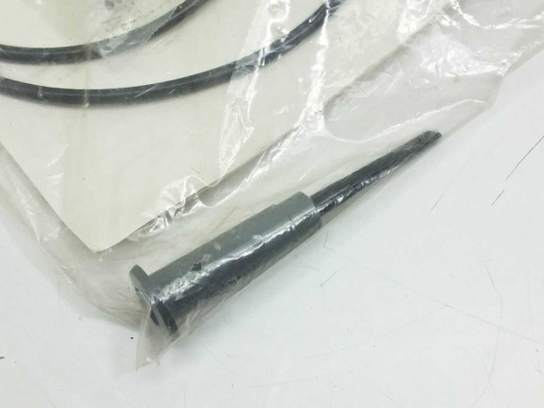 Close-up of Tektronix P6008 probe tip with retractable hook tip accessory and ground clip visible