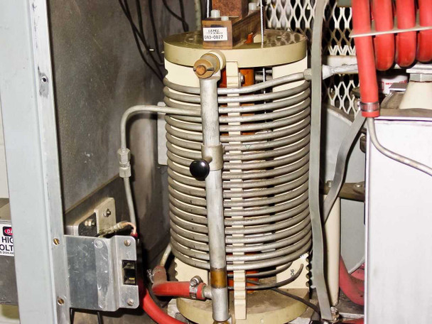 Close-up of large water-cooled helical tank inductor coil with Lepel label tag inside RF Generator