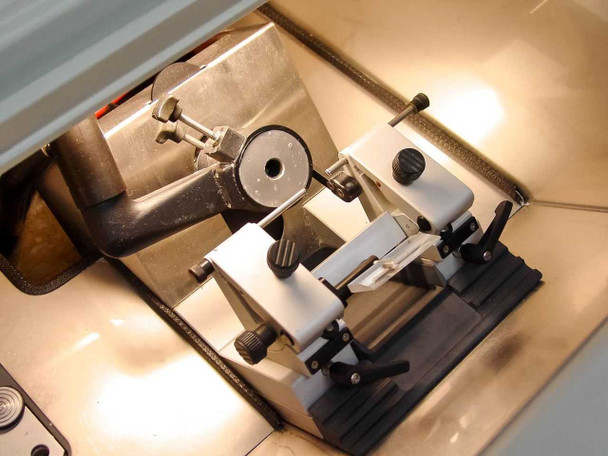 Microm HM500 OM interior close-up – microtome cutting head with blade holder, specimen clamp assembly, and anti-roll plate