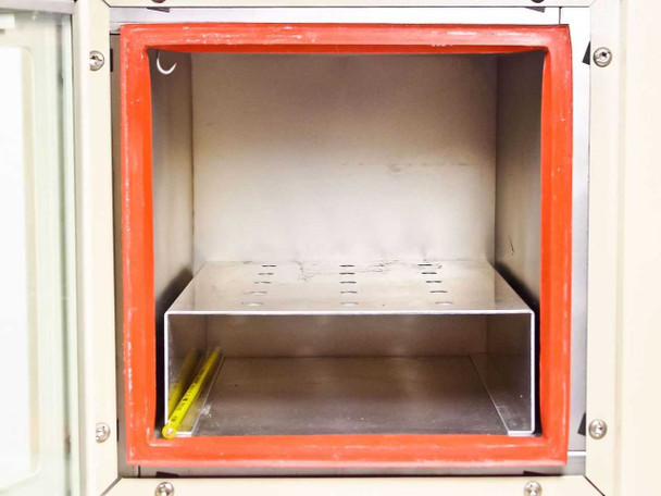 Napco 5831 Vacuum Oven – interior chamber view showing red silicone door seal, stainless steel walls, and perforated stainless shelf tray with yellow thermometer on floor