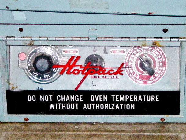 Hotpack 733 Vacuum Oven control panel close-up — brand logo, vacuum/timer dial, temperature controller dial, and 'Do Not Change Oven Temperature Without Authorization' label
