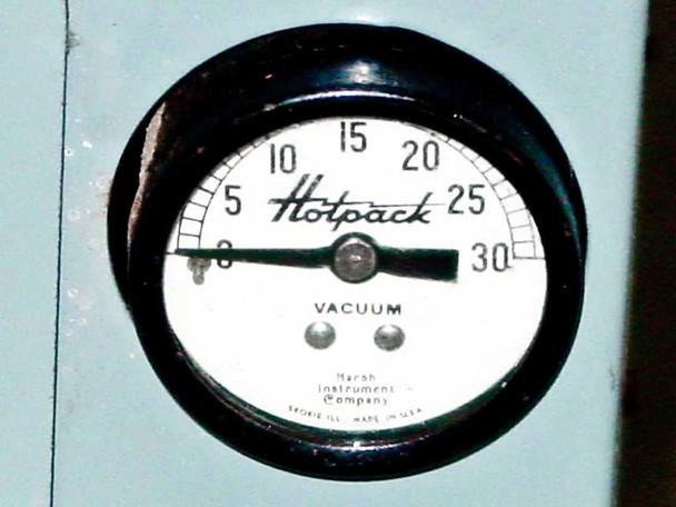 Hotpack vacuum gauge close-up — Marsh Instrument Company 0 to 30 in Hg dial mounted on oven side panel