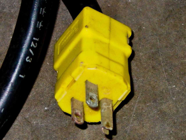 Hotpack 733 power cord yellow 3-prong plug close-up — 12/3 gauge cord, prongs show wear and discoloration
