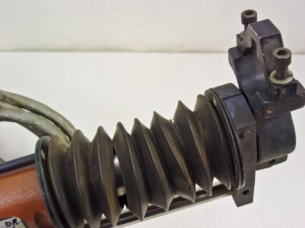 Close-up of AVC-2 accordion rubber bellows and carriage end bracket with adjustment screws — shows bellows condition and carriage detail