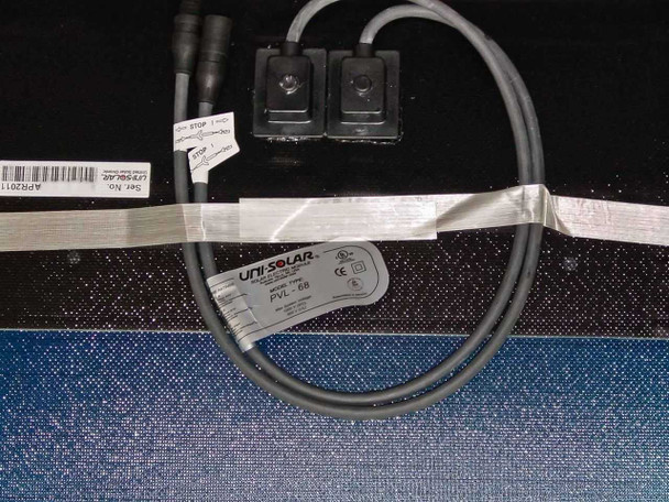 Uni-Solar PVL-68 solar panel rear view showing MC3 cable routing, output connectors, and product labels