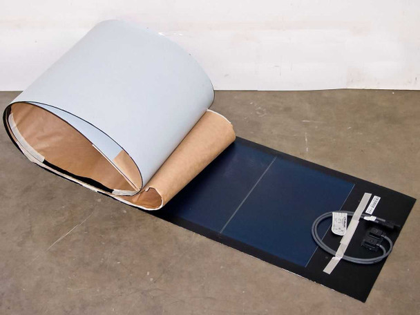 Uni-Solar PVL-68 flexible amorphous solar panel partially unrolled showing blue photovoltaic surface and MC3 output cable