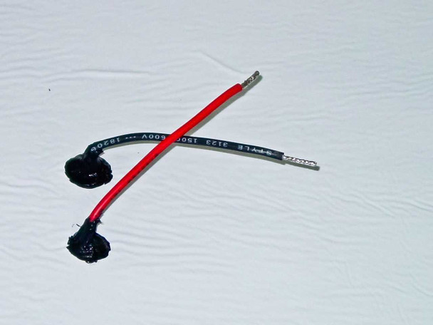 Uni-Solar PVL-128 bottom-facing 4-inch output wires — positive (red) and negative (black) leads with weatherproof potted connectors
