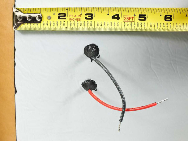 Uni-Solar PVL-128 output wire length shown against tape measure, approximately 4 inches for positive and negative leads