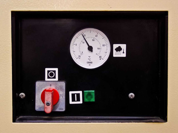 TMS 0140 front control panel close-up showing Jumo analog thermometer, red rotary on/off switch, green indicator button, and dew point indicator icon
