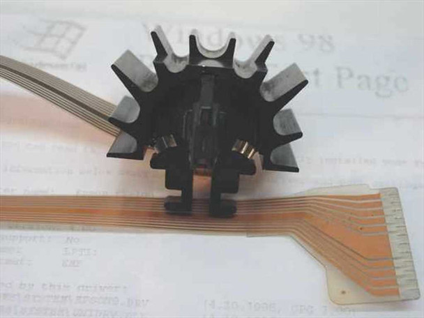 Epson FX-100 dot matrix printhead with ribbon flex cable extended — slightly elevated angle view