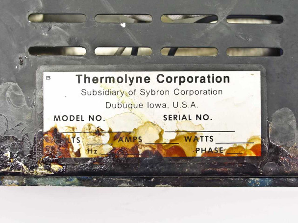 Thermolyne Corporation bottom label close-up – shows Subsidiary of Sybron Corporation, Dubuque Iowa USA; model and serial number fields present but obscured by corrosion damage