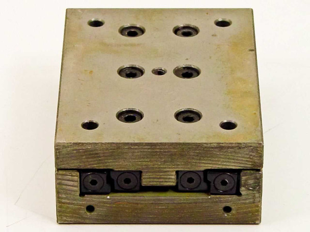 Schneeberger linear slide top-down view showing grid pattern of approximately twelve tapped mounting holes across the steel upper platform surface