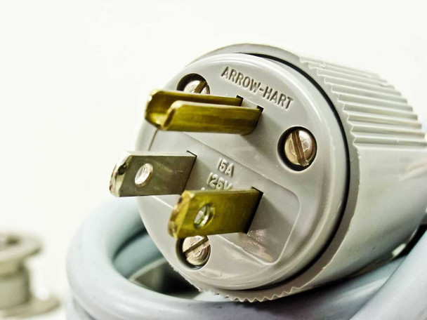 Balzers Pfeiffer DUO 016B power cord plug closeup — Arrow-Hart brand, 6A 125V US NEMA plug with brass blades