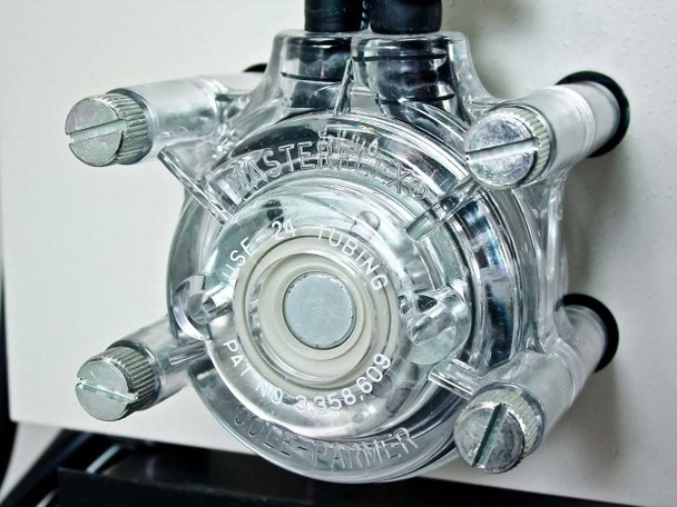 Cole Parmer Masterflex peristaltic pump head close-up showing clear acrylic housing, USE-24 tubing designation, and Cole-Parmer branding