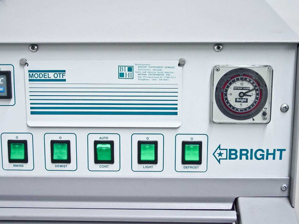 Bright OTF cryostat top panel showing Model OTF label, Bright Instrument Company contact sticker, analog defrost clock, and illuminated Mains/Demist/Cont/Light/Defrost push buttons