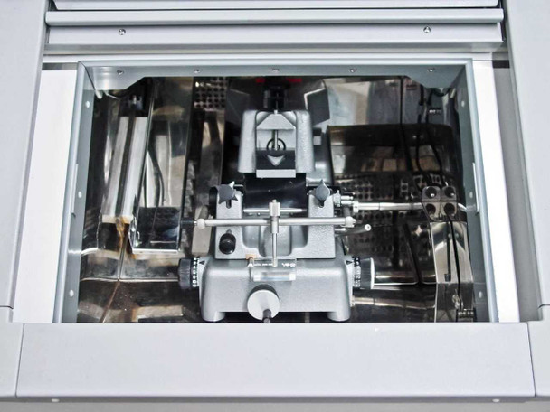 Interior of Bright OTF cryochamber with lid open showing Bright 5030-RR8 rotary microtome mechanism with blade holder, specimen stage, and stainless steel chamber walls
