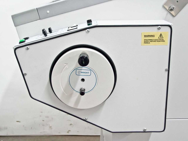 Bright Instrument OTF left-side panel showing circular drive wheel housing with Bright logo and warning label to disconnect electrical supply before removing panels
