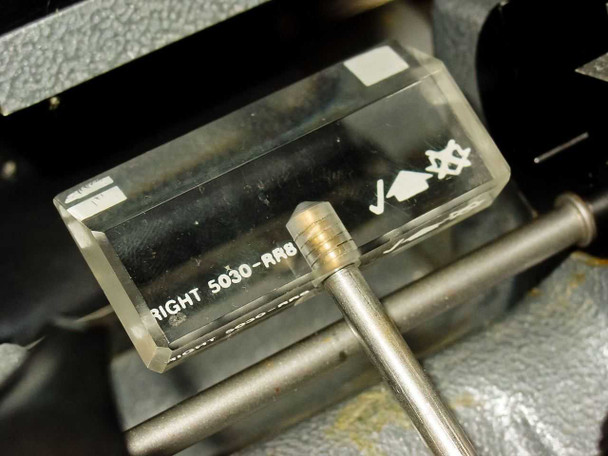 Bright 5030-ARB anti-roll plate close-up showing clear acrylic plate with Bright model label and blade-hazard warning symbol, with section rod