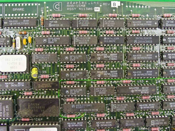 Adaptec AHA-1540 SCSI controller card — close-up of component side PCB showing 'AHA-1540 REV B ASSY 411306-04' label, Motorola and TI DIP ICs, yellow capacitor, and 'SPARE' marking